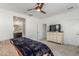 Comfortable main bedroom with a ceiling fan, plush carpeting, and an en-suite bathroom, offering a private retreat at 25601 N 140Th Ln, Surprise, AZ 85387