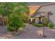 Expansive backyard with a covered patio, mature trees, flowerbeds and decorative landscaping at 2567 E San Isido Trl, Casa Grande, AZ 85194