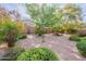Picturesque backyard featuring lush landscaping, a decorative windmill and a rock waterfall at 2567 E San Isido Trl, Casa Grande, AZ 85194