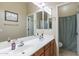 Bathroom featuring double sinks, a large mirror, and a separate room with a toilet and shower, offering functionality at 2567 E San Isido Trl, Casa Grande, AZ 85194
