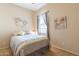 Bedroom featuring a ceiling fan, window with curtains, and a comfortable bed, creating a serene space at 2567 E San Isido Trl, Casa Grande, AZ 85194