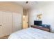 Bedroom featuring a ceiling fan, large closet, and a bed with a patterned quilt, creating a comfortable space at 2567 E San Isido Trl, Casa Grande, AZ 85194