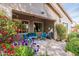 Stylish covered patio featuring blue furniture and views of the beautifully landscaped backyard at 2567 E San Isido Trl, Casa Grande, AZ 85194