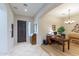 Inviting entryway featuring tile flooring, a wooden front door, and an adjacent home office space with a wooden desk at 2567 E San Isido Trl, Casa Grande, AZ 85194