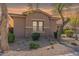 Charming home featuring a stone base, neutral stucco, desert landscaping, and a tile roof at 2567 E San Isido Trl, Casa Grande, AZ 85194