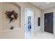 Hallway with archway and view into bedroom. A decorative wreath adorns a niche, enhancing the home's welcoming atmosphere at 2567 E San Isido Trl, Casa Grande, AZ 85194