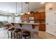 Charming kitchen with light wood cabinets, a breakfast bar with stools, and pendant lighting, perfect for casual dining at 2567 E San Isido Trl, Casa Grande, AZ 85194