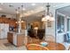 A kitchen with an island sink, connecting to a living room and dining area, with light wood cabinets at 2567 E San Isido Trl, Casa Grande, AZ 85194