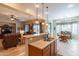 An open kitchen island features a sink and a view to the living room and breakfast nook with a window at 2567 E San Isido Trl, Casa Grande, AZ 85194