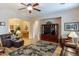 Spacious living room with hardwood floors, a ceiling fan, and an entertainment center, great for Gathering gatherings at 2567 E San Isido Trl, Casa Grande, AZ 85194