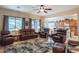 Inviting living room with hardwood floors, large windows, and an open layout to the kitchen, ideal for entertaining at 2567 E San Isido Trl, Casa Grande, AZ 85194