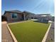 Spacious backyard with artificial grass, covered patio, and separate gazebo seating area at 25968 W Tina Ln, Buckeye, AZ 85396