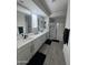 Modern bathroom featuring double sinks, sleek fixtures, and a glass-enclosed shower at 25968 W Tina Ln, Buckeye, AZ 85396