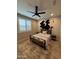 Cozy bedroom featuring a modern ceiling fan, and stylish furnishings, including a decorative cowhide wall hanging at 25968 W Tina Ln, Buckeye, AZ 85396