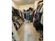 Walk-in closet features ample shelving and hanging space for organized storage of clothes and accessories at 25968 W Tina Ln, Buckeye, AZ 85396