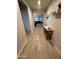 Inviting hallway featuring wood-look tile flooring and stylish decor, leading to the living spaces at 25968 W Tina Ln, Buckeye, AZ 85396