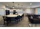 Open-concept kitchen featuring a large island with seating, white cabinets, and modern appliances at 25968 W Tina Ln, Buckeye, AZ 85396