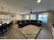 Spacious living room featuring tile floors, a large sectional sofa, and ample natural light at 25968 W Tina Ln, Buckeye, AZ 85396