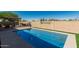 Large backyard with a private pool, artificial turf, and an outdoor kitchen with shade at 26264 N 74Th Ln, Peoria, AZ 85383