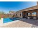 Home exterior with a private pool, covered patio area, neutral stucco, and low-maintenance landscaping at 26264 N 74Th Ln, Peoria, AZ 85383