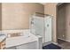 Relaxing bathroom showcasing a soaking tub and a separate glass-enclosed shower at 26264 N 74Th Ln, Peoria, AZ 85383