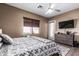 Comfortable bedroom with warm tones, tile floor, ceiling fan, window, and access to the backyard at 26264 N 74Th Ln, Peoria, AZ 85383