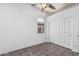 Neutral-toned bedroom with tile flooring, standard window, and closet with bi-fold doors at 26264 N 74Th Ln, Peoria, AZ 85383