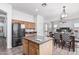 Open kitchen features stainless appliances, center island, and adjacent dining area, creating a social space at 26264 N 74Th Ln, Peoria, AZ 85383