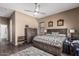 Inviting main bedroom with neutral walls, tile floor, a large window, and cozy furnishings at 26264 N 74Th Ln, Peoria, AZ 85383