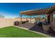 Backyard boasts an outdoor kitchen with a pergola, artificial turf, a private pool, and mountain views at 26264 N 74Th Ln, Peoria, AZ 85383