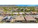 Aerial view shows the homes with well-kept yards and desert landscaping in a community at 27562 N 99Th Dr, Peoria, AZ 85383