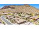 Stunning aerial view of a desert community with beautiful homes and mountain views at 27562 N 99Th Dr, Peoria, AZ 85383