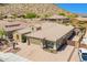 Aerial view showcases desert landscaping, tile roof, and a spacious three-car driveway at 27562 N 99Th Dr, Peoria, AZ 85383