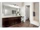 Bright bathroom featuring a dark wood vanity, a makeup area, and a separate shower at 27562 N 99Th Dr, Peoria, AZ 85383