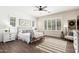 The bedroom features a neutral color scheme, wood-look tile, and plantation shutters at 27562 N 99Th Dr, Peoria, AZ 85383