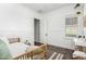 Bright guest bedroom with stylish decor, wood-look tile flooring, and large window at 27562 N 99Th Dr, Peoria, AZ 85383