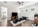 Bonus room features modern ceiling fan, wood-look tile, and stylish black gaming chairs with white accent rug at 27562 N 99Th Dr, Peoria, AZ 85383