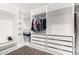A spacious walk-in closet with white shelving offers ample storage and organization options at 27562 N 99Th Dr, Peoria, AZ 85383