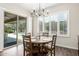 Charming dining area with wood-look floors, a wooden table, and sliding doors that open to the pool at 27562 N 99Th Dr, Peoria, AZ 85383