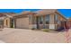 Exterior view featuring a paved driveway leading to a home with desert landscaping at 27562 N 99Th Dr, Peoria, AZ 85383
