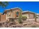 Charming single-story home with a desert-style front yard and a two-car garage at 27562 N 99Th Dr, Peoria, AZ 85383