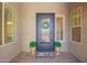 Charming front door with decorative wreath and potted greenery at 27562 N 99Th Dr, Peoria, AZ 85383