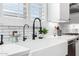 Updated white kitchen design with farmhouse sink and stainless steel appliances at 27562 N 99Th Dr, Peoria, AZ 85383