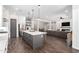 Open-concept kitchen featuring a large island and views into the adjacent living room at 27562 N 99Th Dr, Peoria, AZ 85383