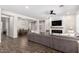 Open-concept living area with a fireplace, and wood-look floors, providing a seamless flow at 27562 N 99Th Dr, Peoria, AZ 85383