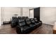 The media room is equipped with plush leather recliners for a luxurious viewing experience at 27562 N 99Th Dr, Peoria, AZ 85383
