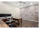 Office with exposed brick wall, custom desk, and new flooring at 27562 N 99Th Dr, Peoria, AZ 85383