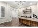 Bright office featuring French doors, a wooden desk, and ample shelving at 27562 N 99Th Dr, Peoria, AZ 85383