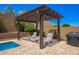 Outdoor entertaining area complete with lounge chairs, pergola and barbecue grill, great for gatherings at 27562 N 99Th Dr, Peoria, AZ 85383