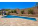 A private pool area surrounded by travertine, with a large pool for outdoor enjoyment at 27562 N 99Th Dr, Peoria, AZ 85383